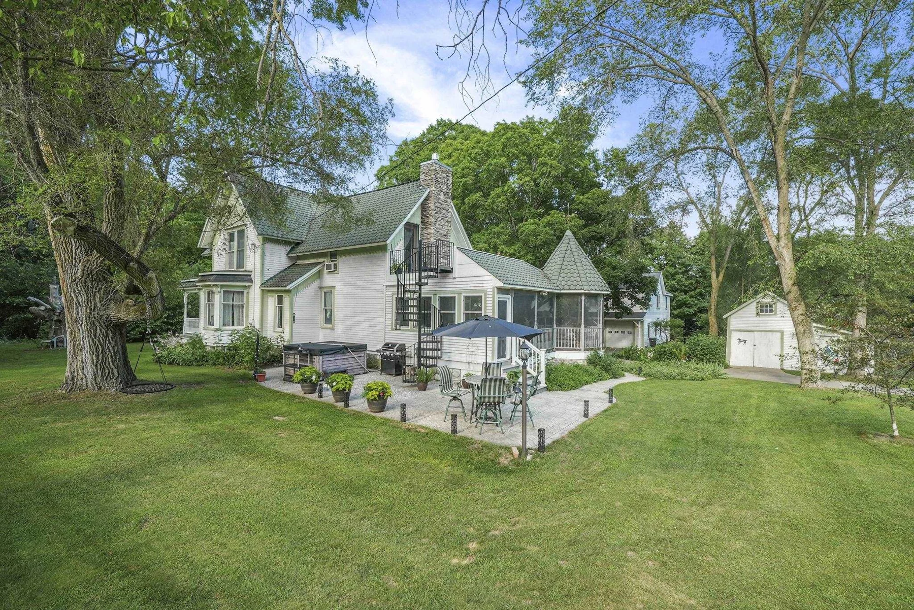 The farmhouse framed by mature trees